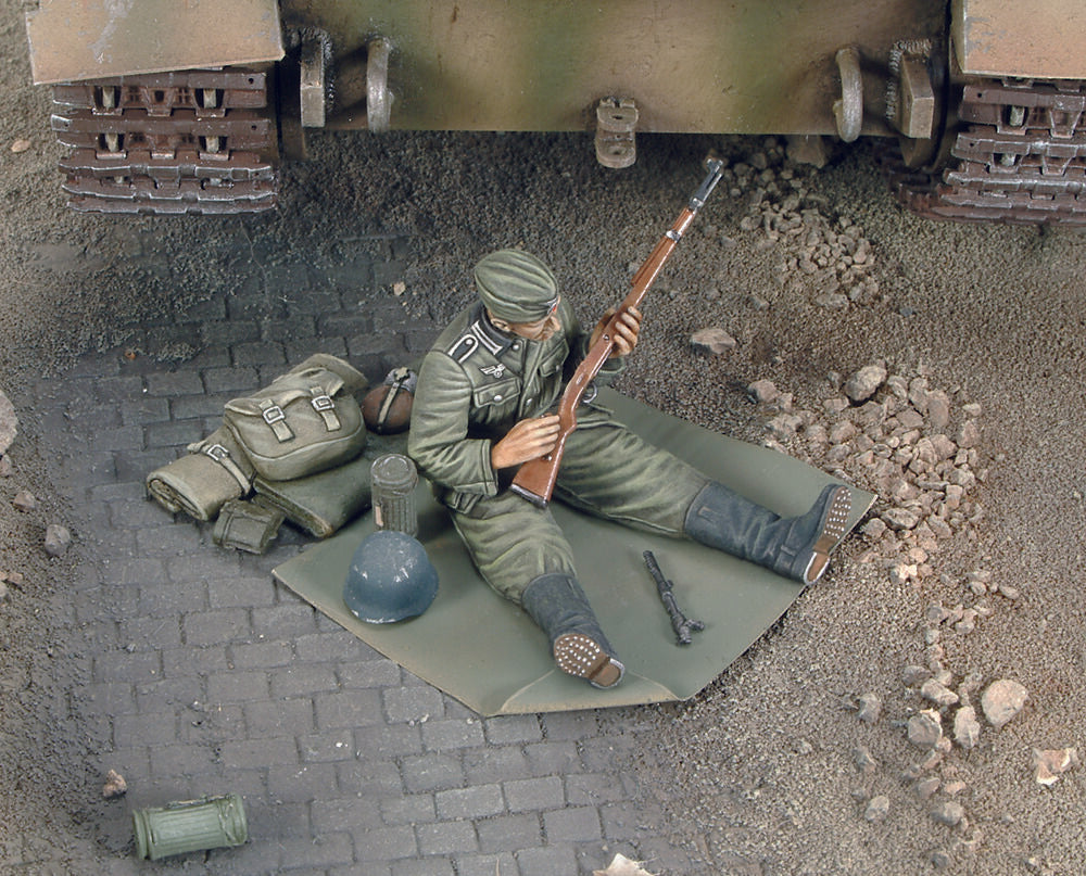 German soldier cleans up his rifle-WWII